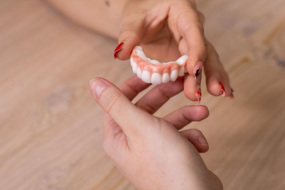 A woman examining her dental work, nashville tn